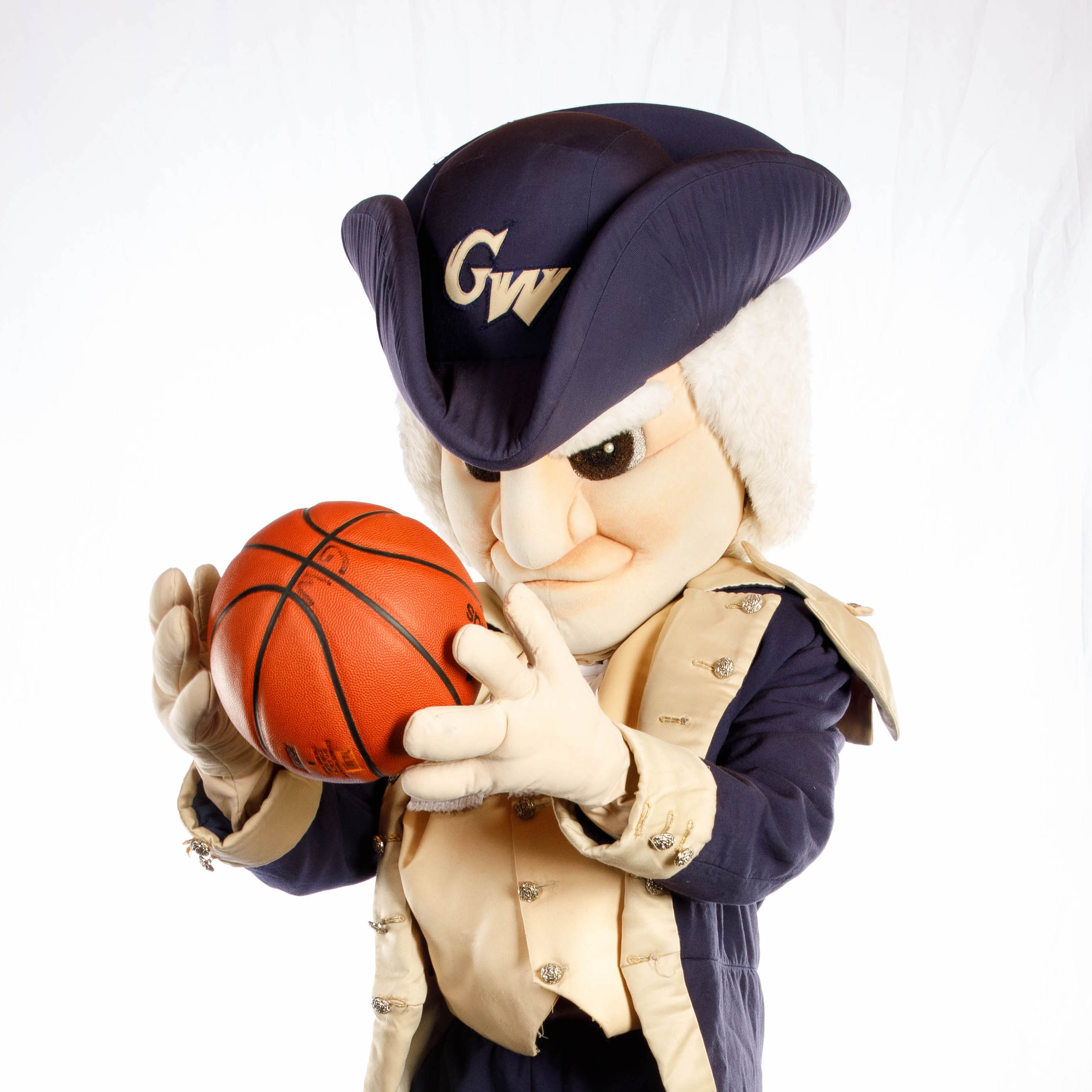 GW's George Mascot holding a basketball